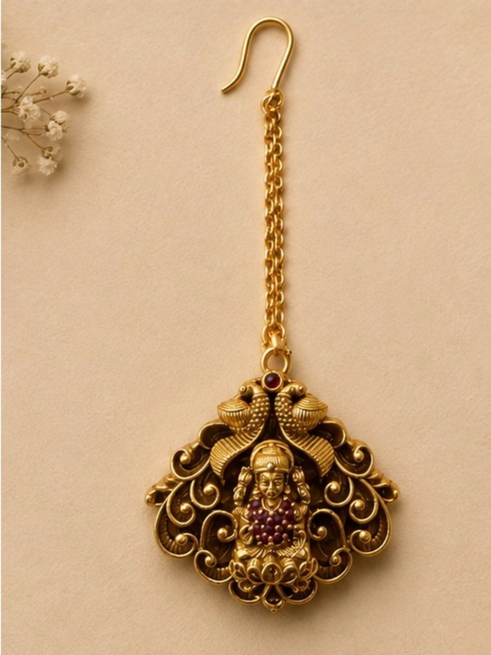 Gold-Tone Lakshmi Maang Tikka with Ruby accents.